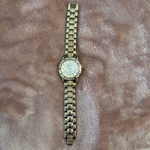 Watch, gold toned, mother of pearl face with cubic accents
